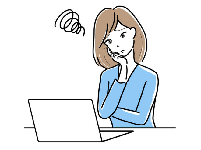 パソコンを前に困る女性